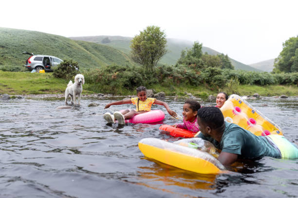 istock Family Of Four Chilling In A River 2197612799