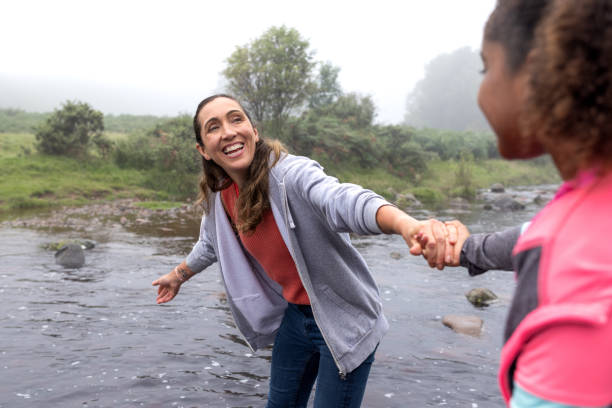 istock Mother Holding Daughters hand On Walk 2197613017
