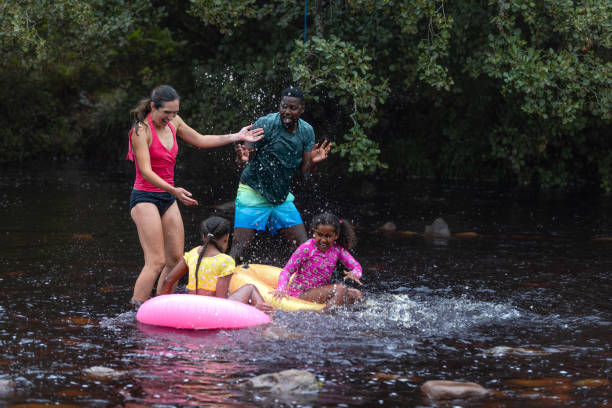 istock Family Enjoying A Playful Day In the River 2197613144