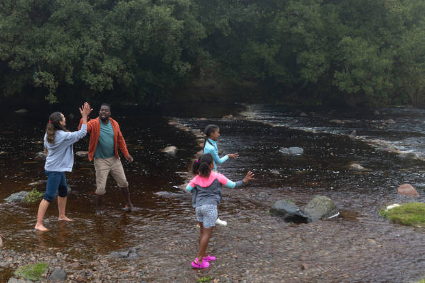 istock Joyful Family Enjoying A Fun Day By The River 2197613204
