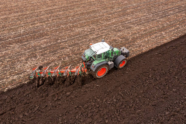 Tractor plowing field stock photo