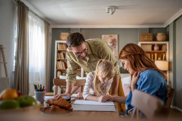 istock Parents and daughter enjoying a coloring activity 2197615177