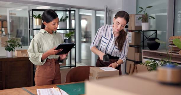 istock Box, scanner and tablet for supply chain with women in delivery or distribution office together. Backlog, order or shipping with logistics employee team in workplace for checklist or ecommerce 2197615829