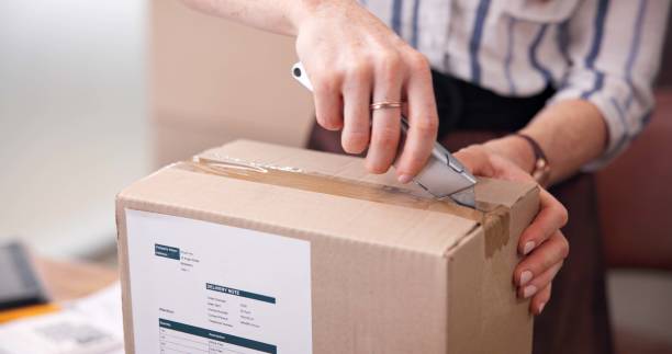 istock Hands, box and open for shipping, online shopping and delivery for distribution at small business. Woman, cardboard and packaging with seal for product, safety and cargo in supply chain at startup 2197615844