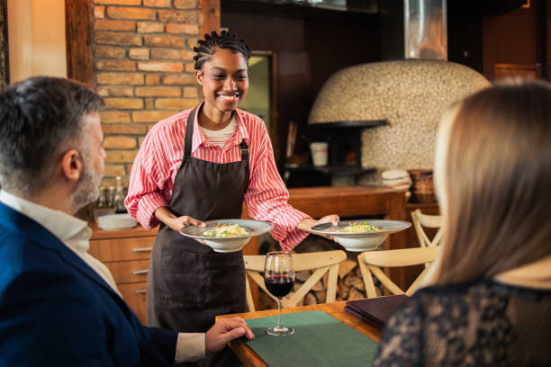 istock A server bringing food to a couple on their special date night 2197616927