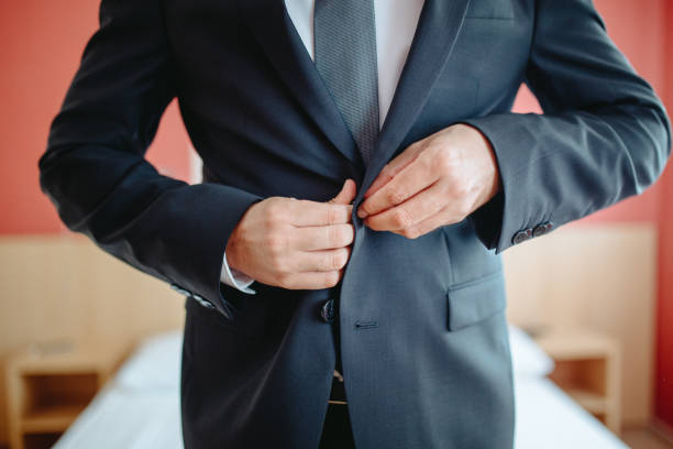 istock Fastening the Suit  A Moment of Confidence 2197617677