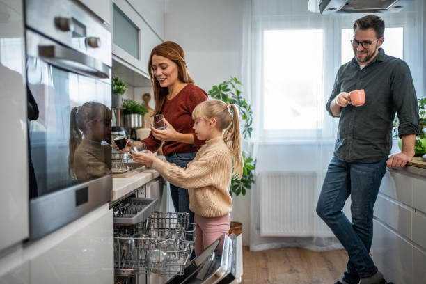istock Mother and daughter loading the dishwasher together 2197617734