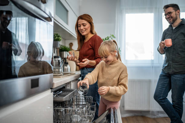 istock Mother and daughter loading the dishwasher together 2197617735