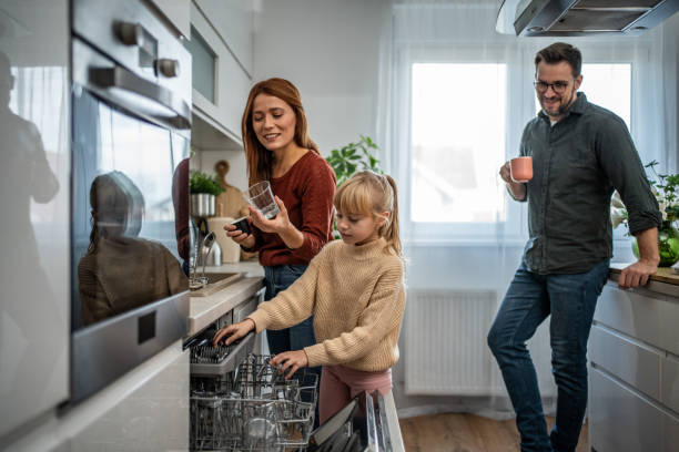istock Mother and daughter loading the dishwasher together 2197617737