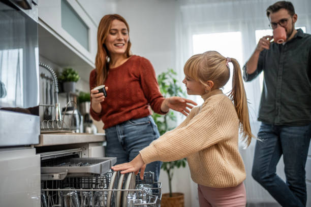 istock Mother and daughter loading the dishwasher together 2197617910