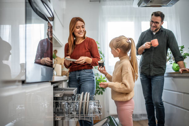 istock Mother and daughter loading the dishwasher together 2197617911