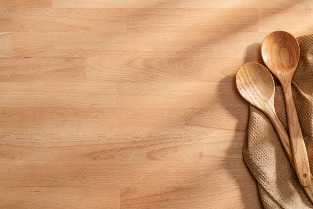 istock Wooden culinary background with two spoons and a tablecloth at the right border making a frame and leaving copy space 2197618092