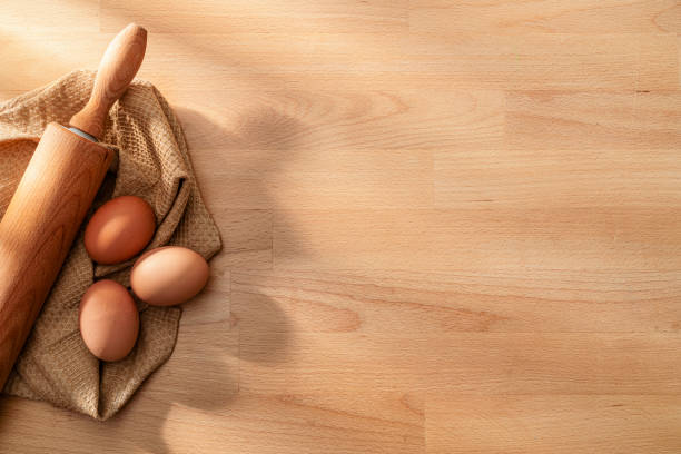 istock Rolling pin and eggs on wooden table. Baking or cooking frame with copy space 2197618130