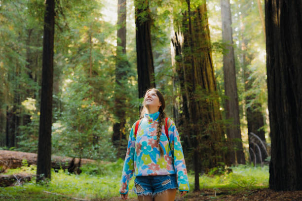 istock Smiling Traveller with Backpack Walking in Redwood Forest During Sunrise 2197619646