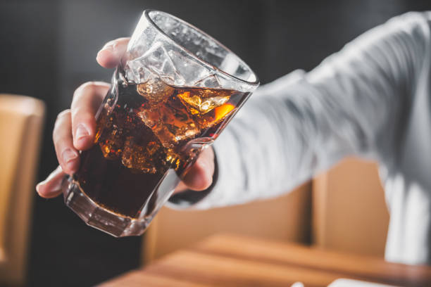 istock man hold pen and notebook and coke ice glass cup 2197621184