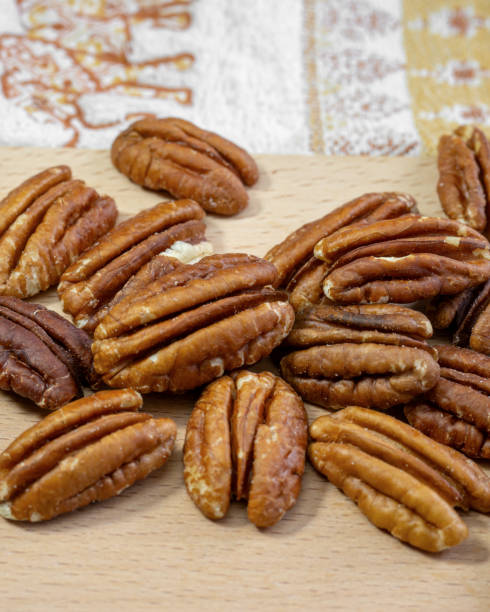 istock Pecan nuts on a wooden table close up 2197621650
