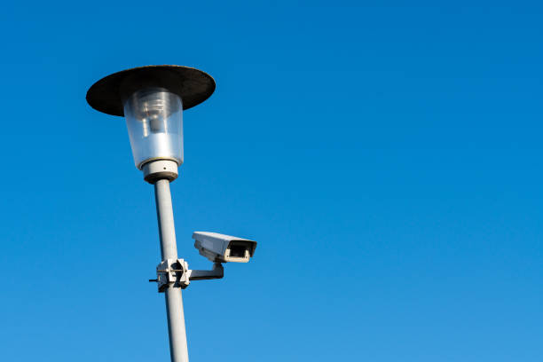 istock Streetlight with surveillance camera against clear blue sky 2197623049