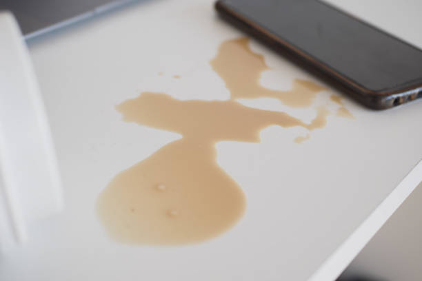 istock A drink was accidentally spilled on a desk with a laptop and glasses, creating a mess 2197623848
