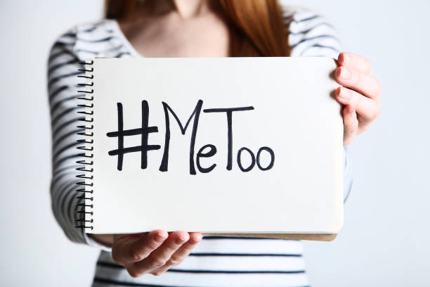 istock Woman holding notepad with text Me Too on grey background 2197624253
