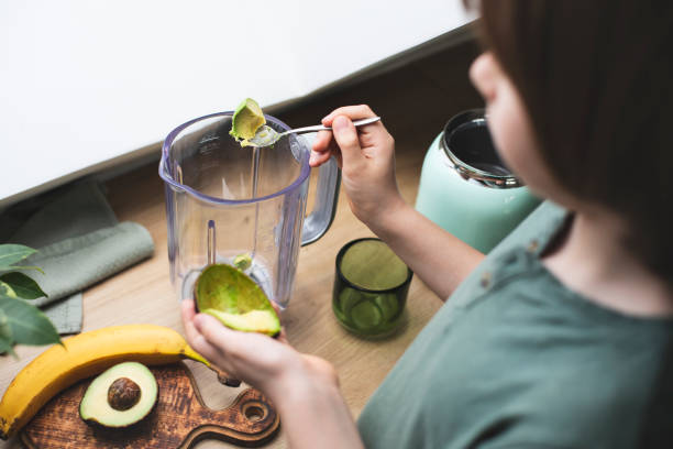 istock Kid making healthy superfood smoothie in a blender 2197624260