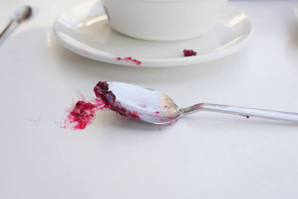 Selective focus of a spoon and fork on a white background