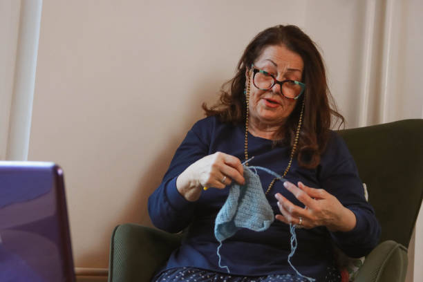 istock Senior woman learns to crochet online 2197624933