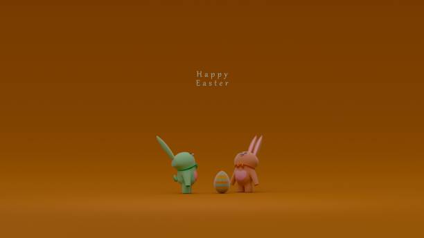 istock Two rabbit figurines with bow ties and heart shapes on their chests standing next to a decorated Easter egg on a brown background with 