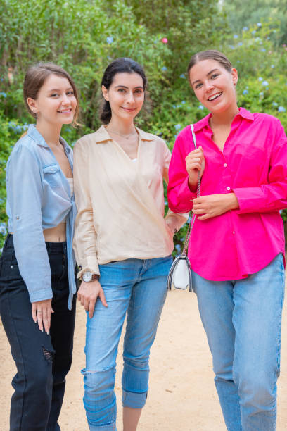 istock Three Happy Women Posing Together in a Green Park.Vertical 2197627542