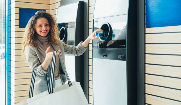 istock Woman recycling plastic bottle via reverse vending machine 2197627615