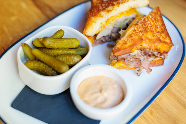 istock grilled beef sandwich with crispy onion rings and greenery on a wooden table 2197627646