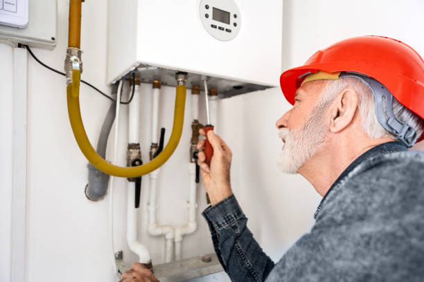 istock Technician With Piping System In The Manifold Wall Cabinet for Modern Floor Heating Unit 2197627866