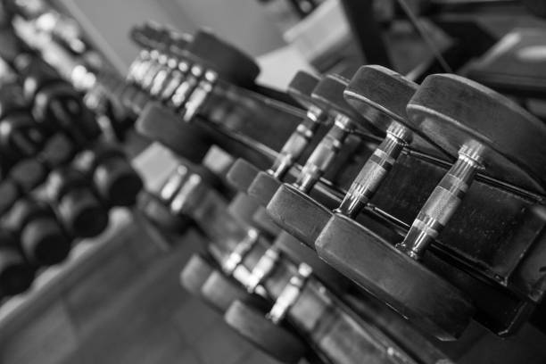 ASSORTMENT OF DUMBBELLS IN A GYM IN THE BRITISH CAPITAL (LONDON) TINTED IMAGE IN BLACK AND WHITE. HEALTHY LIFESTYLE