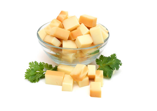 Cubes of cheddar cheese isolated on white