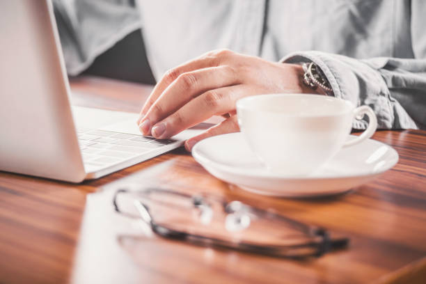 istock Businessman Hands on a Rustic Wooden Table with laptop Computer a Cup of Coffee. 2197631380