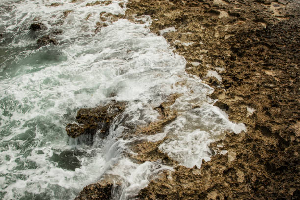 istock Waves Crashing Against Rocky Shoreline 2197631839