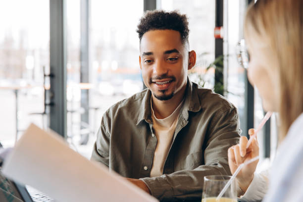 istock Business partners discussing contract during a meeting in a cafe 2197636029