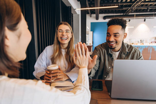 istock Happy business team giving high five celebrating success in office 2197636069