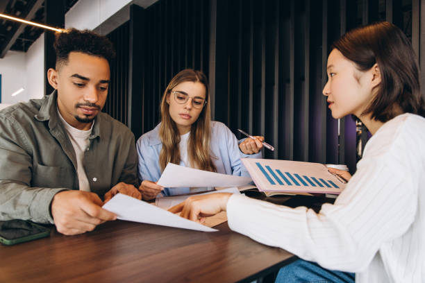 istock Marketing specialists analyzing financial reports and discussing sales growth strategy 2197636090
