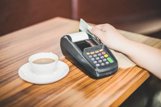 istock A customer paying for coffee with a credit card 2197636583