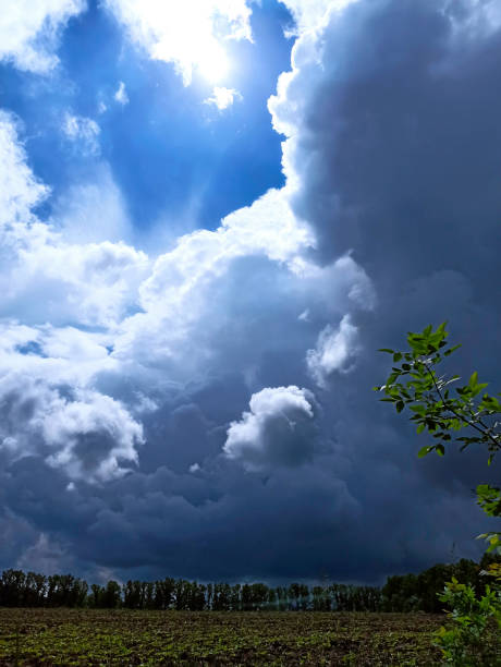 Capricious changeable spring weather. Cumulonimbus clouds form in the sky is associated with inclement weather conditions and thunderstorms.