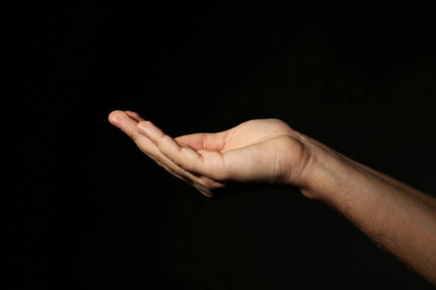 istock Male hand on a black background 2197637486