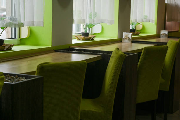 tables by the window in the cafe, flowers on the windows