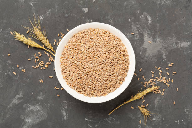 istock Bowl with spelt grain on concrete background, top view 2197638543