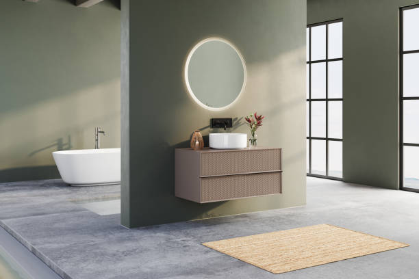 istock Modern bathroom with green walls, round backlit mirror, floating vanity, freestanding bathtub, and minimalist decor in a bright, open space. 3D rendering 2197640591