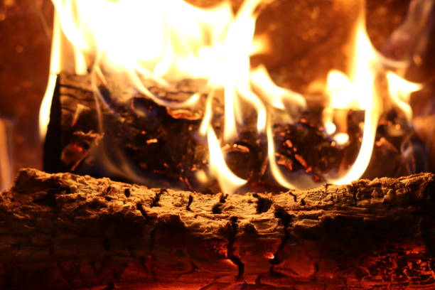 istock Close up of flames on logs in a fireplace 2197645184