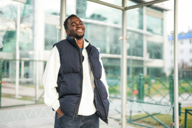 istock african american young man waiting for bus at bus stop 2197646308