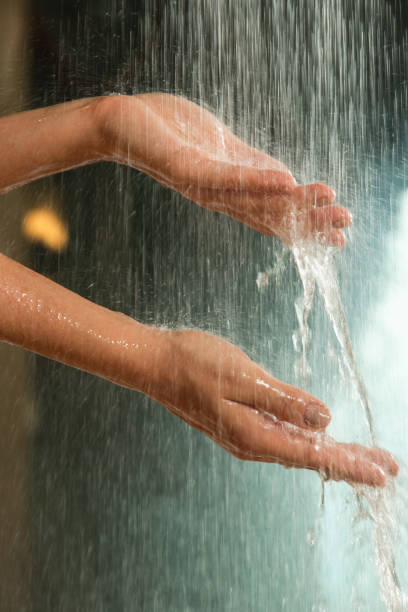 istock Gentle hands under a stream of falling water 2197646598
