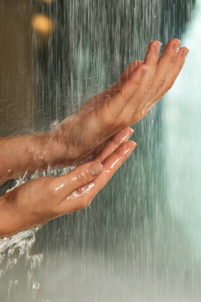 istock Gentle hands under a stream of falling water 2197646645