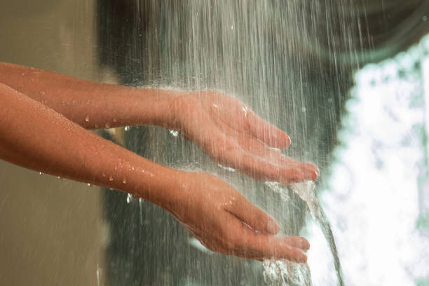 istock Gentle hands under a stream of falling water 2197646691