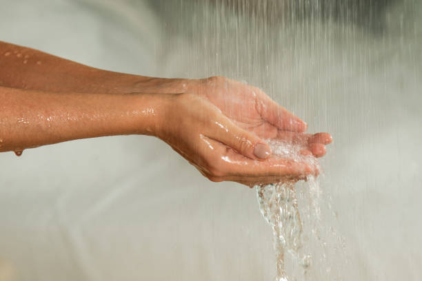 istock Gentle hands under a stream of falling water 2197646714